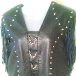 Fringe sleeve, leather vest with rivets and chain
